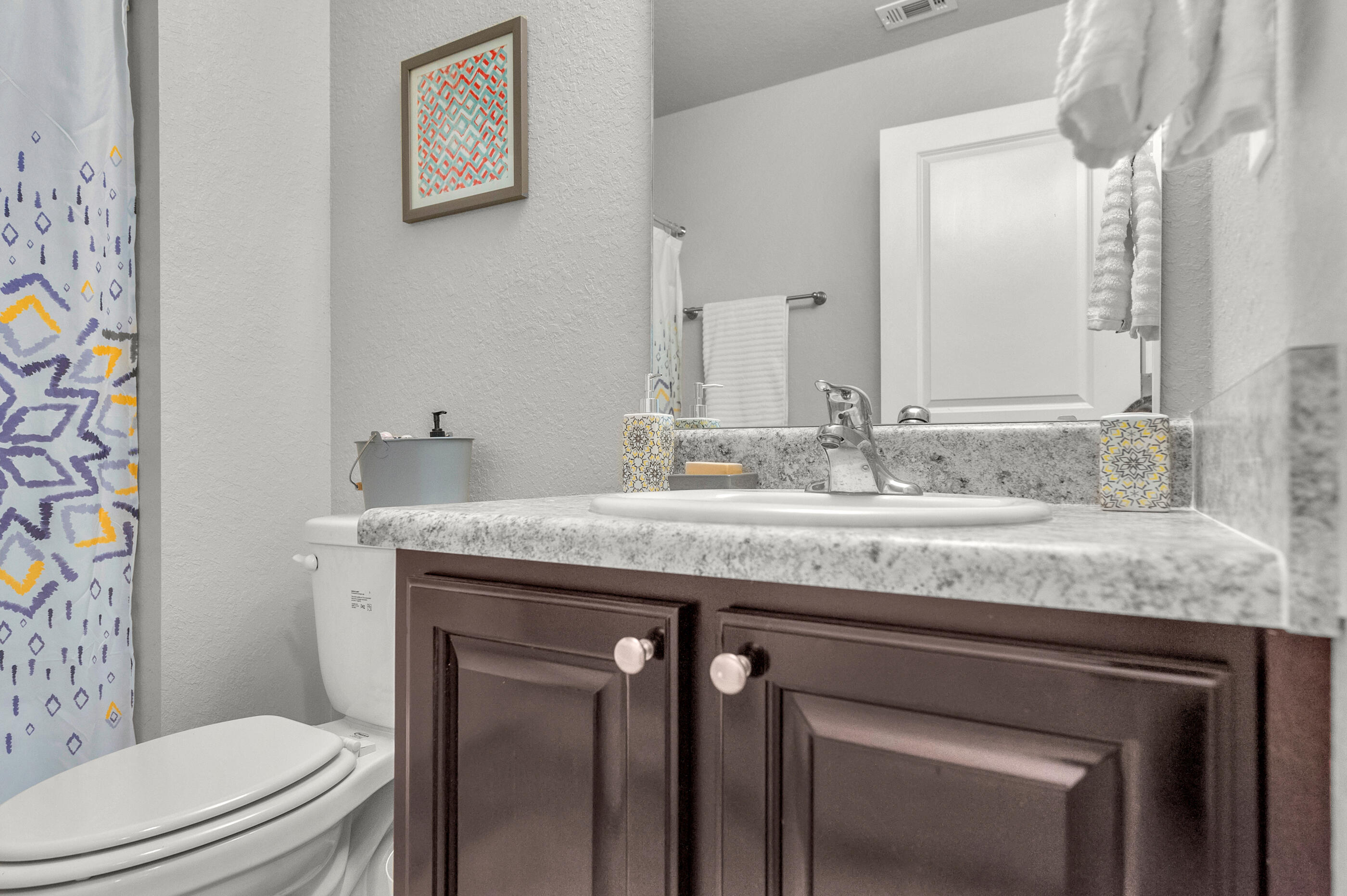 306 Vale Loop Crestview, FL 32536 - Photo 34 of 40 a bathroom with a granite countertop toilet sink and mirror