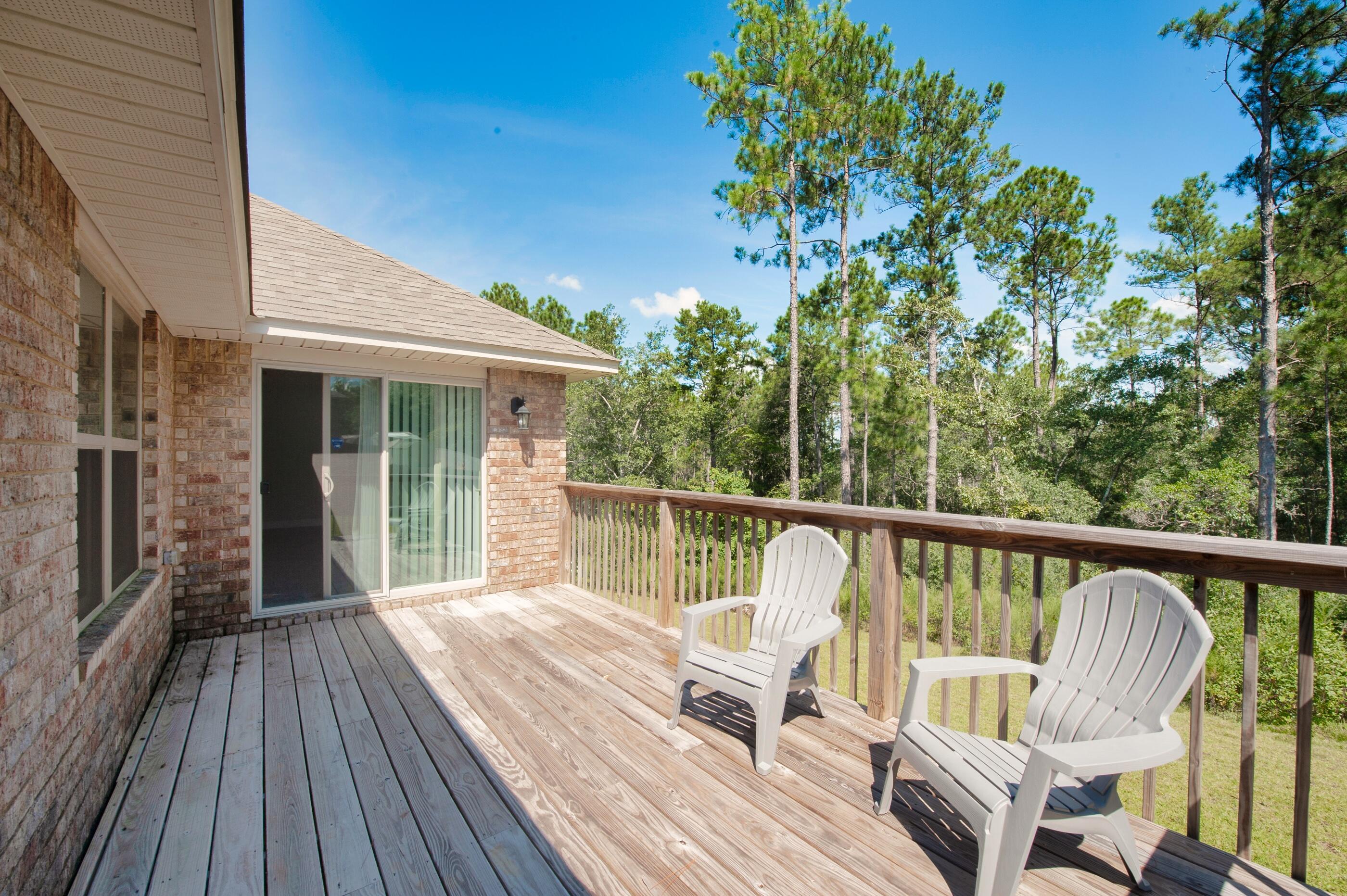 306 Vale Loop Crestview, FL 32536 - Photo 37 of 40 a view of balcony with wooden floor and outdoor seating
