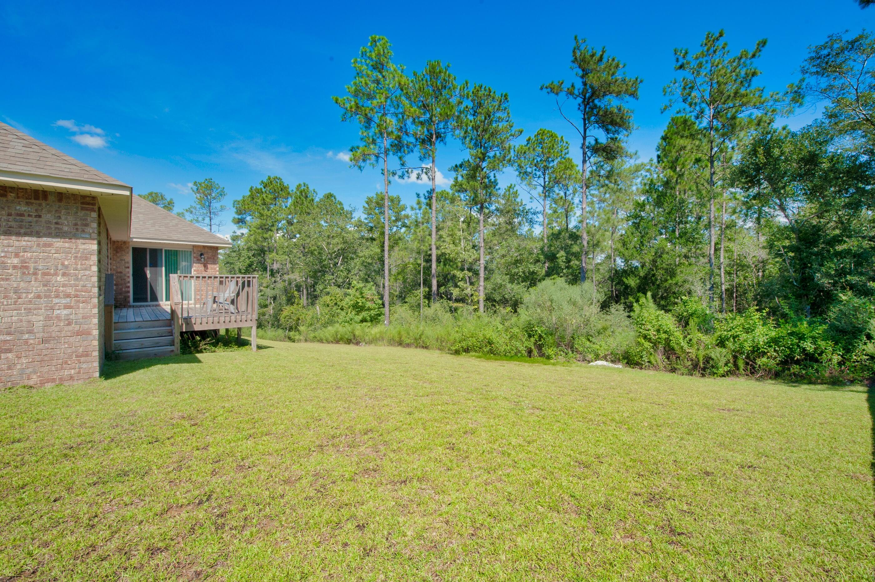 306 Vale Loop Crestview, FL 32536 - Photo 38 of 40 a view of a yard with a tree