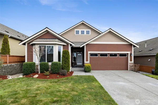 a front view of a house with a yard and garage