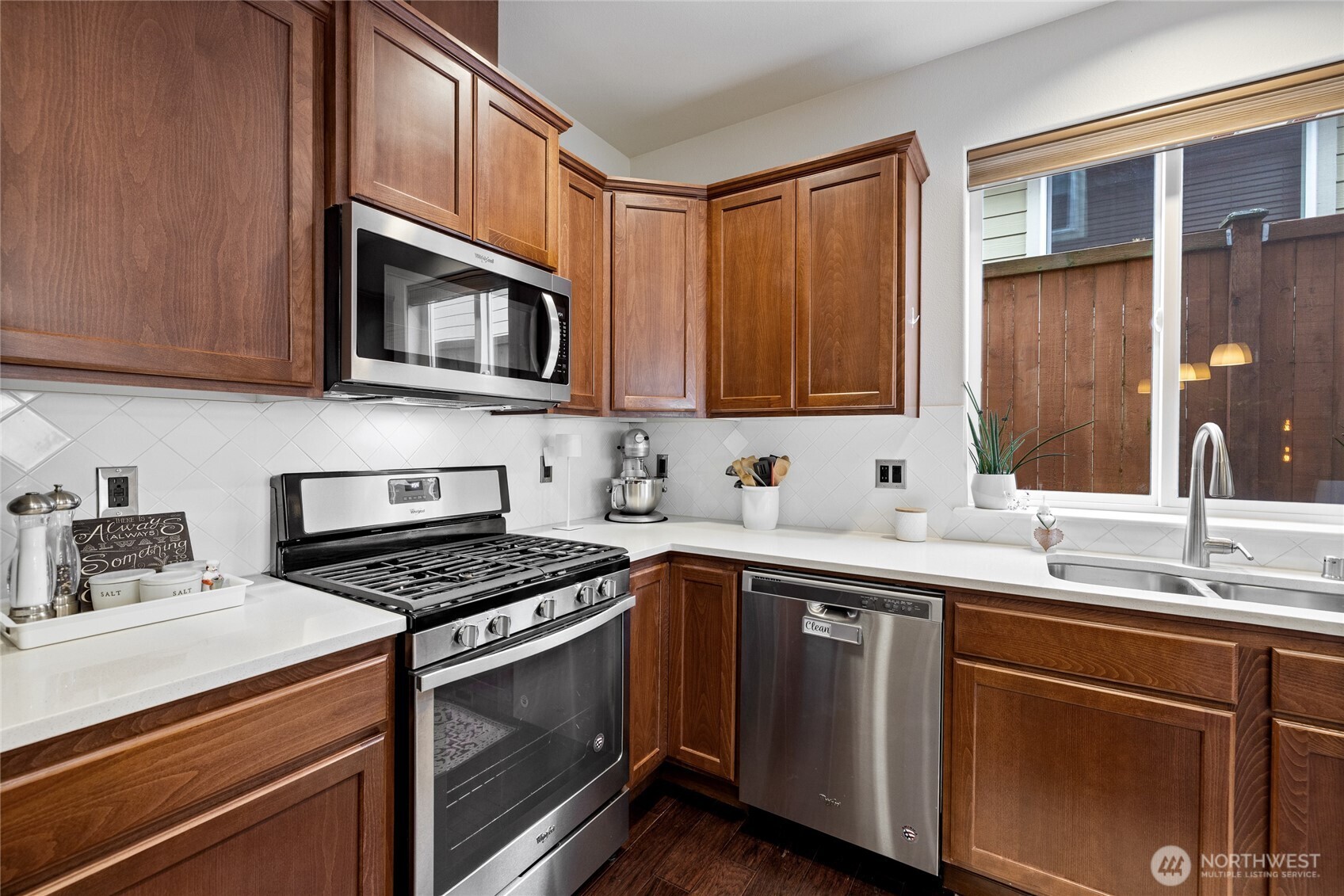 736 Mandee Street Southeast Lacey, WA 98513 - Photo 11 of 35 a kitchen with stainless steel appliances granite countertop a sink stove microwave and cabinets