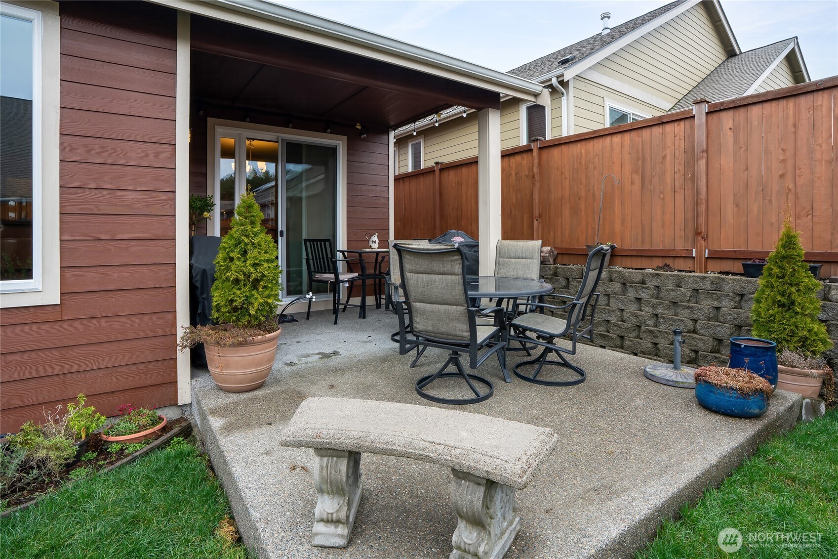 736 Mandee Street Southeast Lacey, WA 98513 - Photo 32 of 35 a view of a patio with table and chairs potted plants and a barbeque