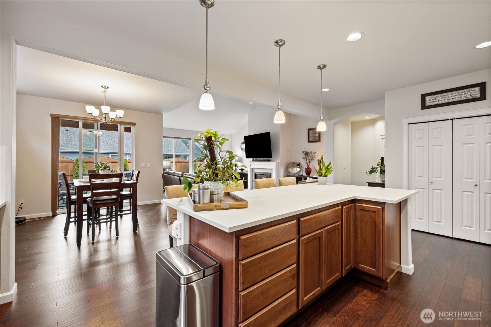 736 Mandee Street Southeast Lacey, WA 98513 - Photo 4 of 35 a open kitchen with stainless steel appliances granite countertop a stove a refrigerator a kitchen island a dining table and chairs with wooden floor