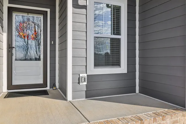 a living room with furniture a fireplace and a ceiling fan