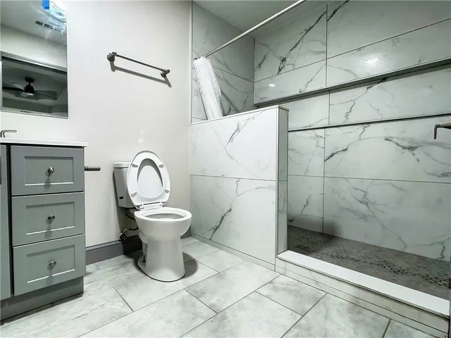a bathroom with a toilet sink and shower