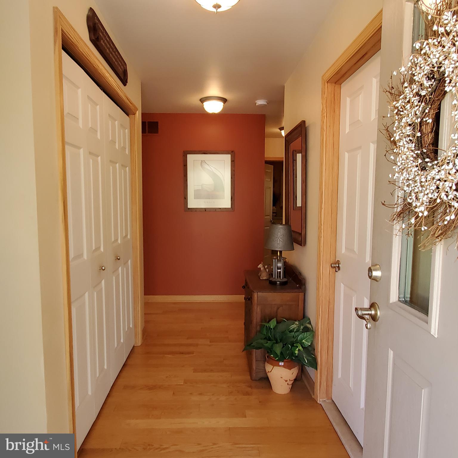 36 Cobbs Mill Road Alloway, NJ 08302 - Photo 15 of 41 a view of a hallway with wooden floor and a dining room