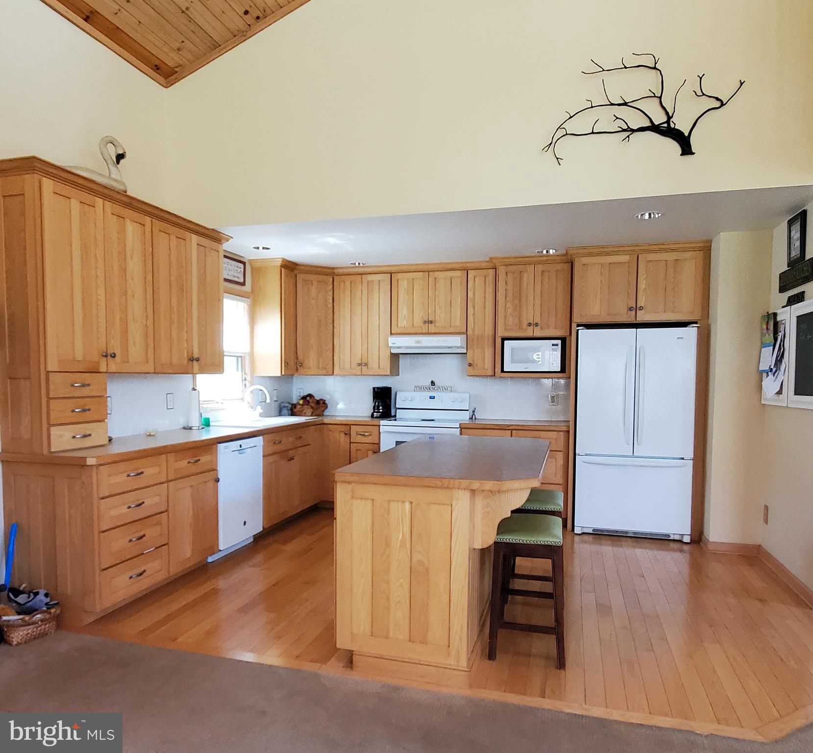 36 Cobbs Mill Road Alloway, NJ 08302 - Photo 19 of 41 a kitchen with kitchen island a stove a refrigerator and a sink with wooden floor