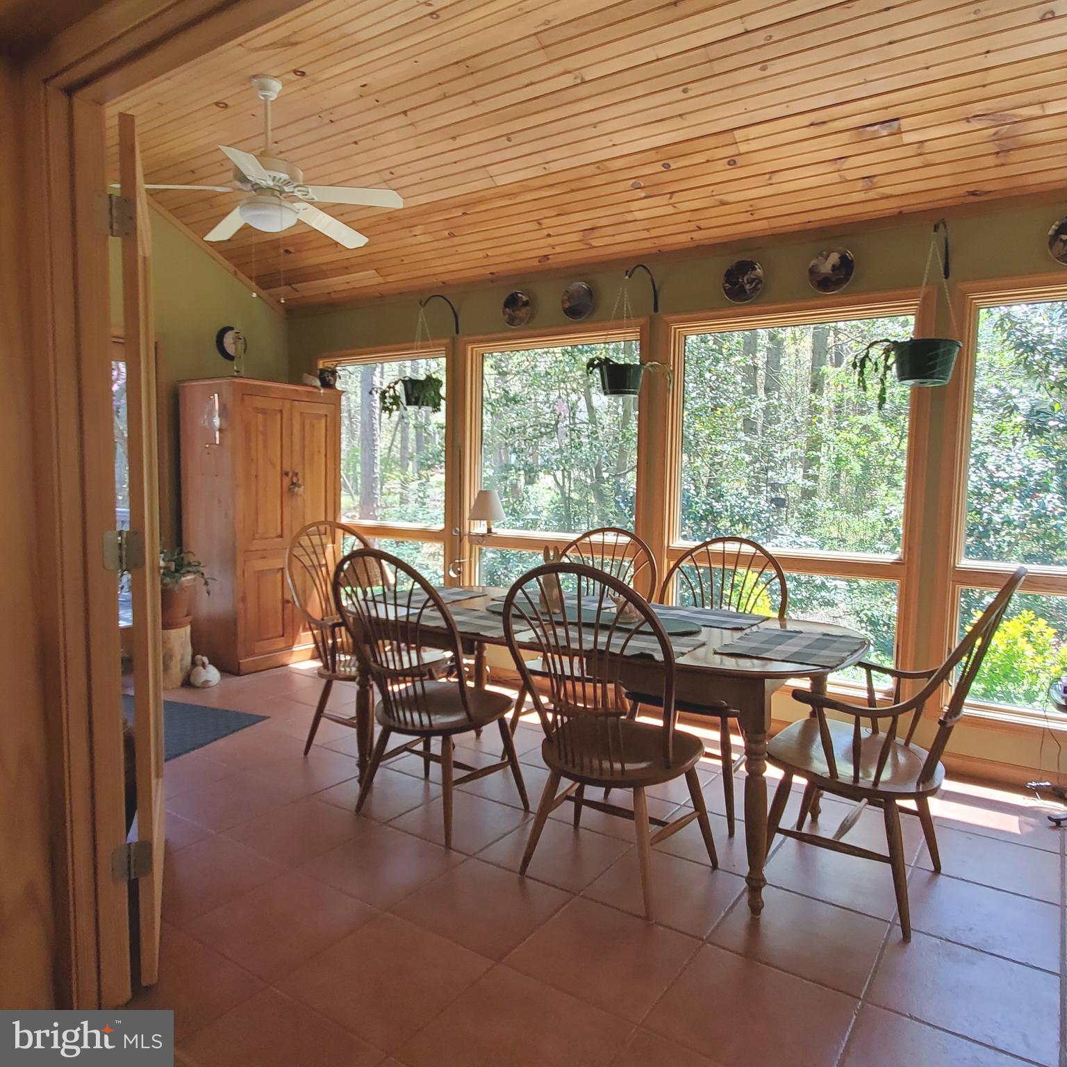 36 Cobbs Mill Road Alloway, NJ 08302 - Photo 21 of 41 a view of a dining room with furniture large windows and wooden floor