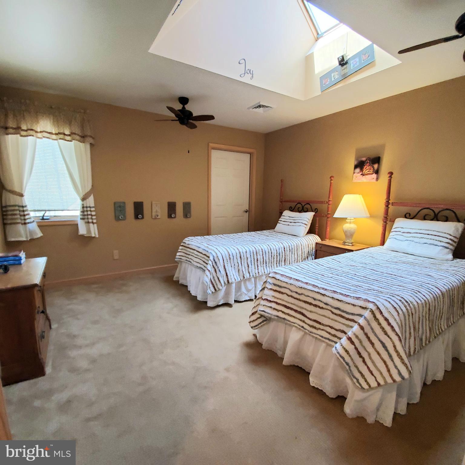 36 Cobbs Mill Road Alloway, NJ 08302 - Photo 35 of 41 a bedroom with two beds and a chandelier