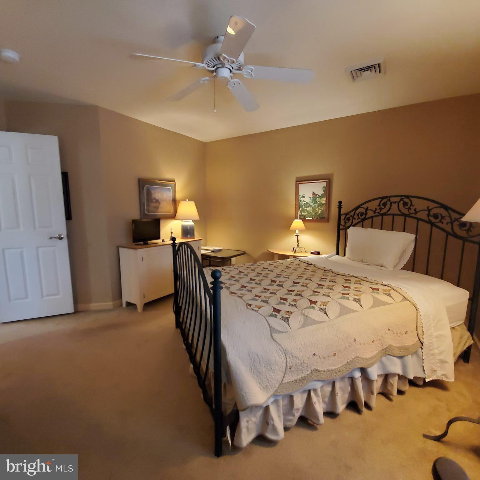 36 Cobbs Mill Road Alloway, NJ 08302 - Photo 38 of 41 a bedroom with a bed and a chandelier