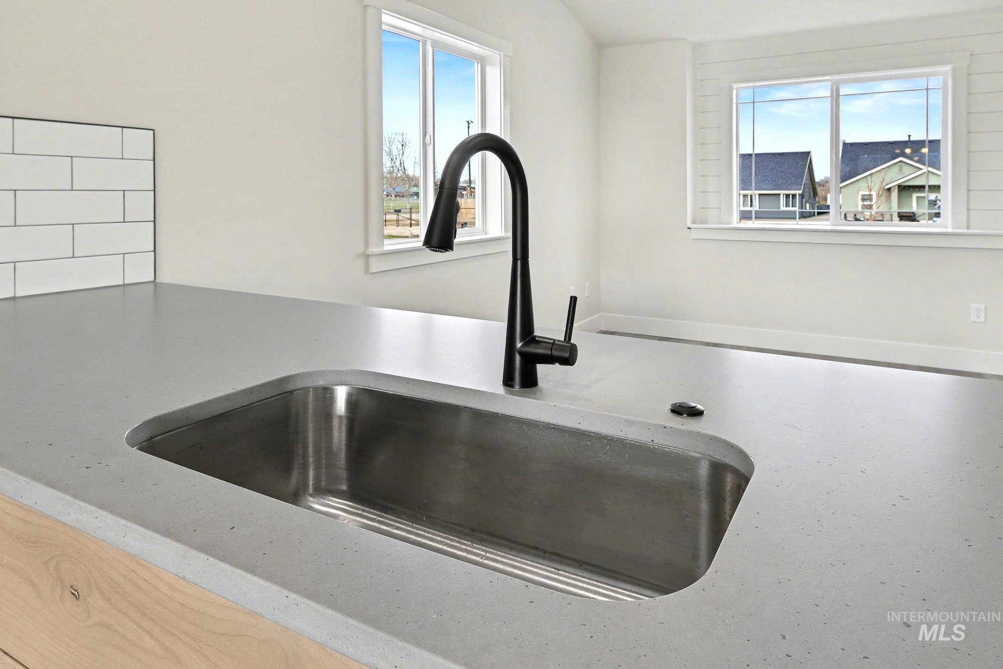 326 Packer Lane Homedale, ID 83628 - Photo 12 of 24 Kitchen view of light stone countertops and tasteful backsplash