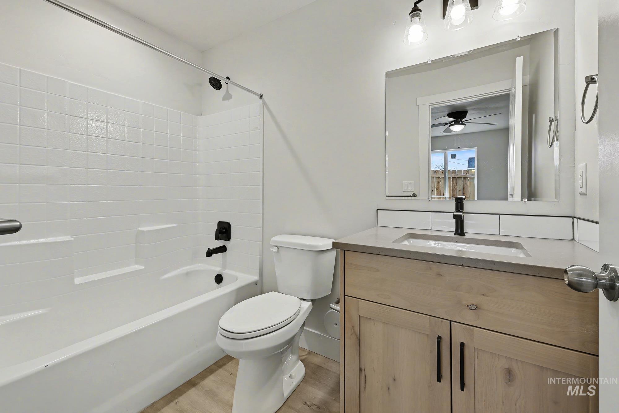 326 Packer Lane Homedale, ID 83628 - Photo 17 of 24 Full bath with vanity, shower combination, and light wood-style flooring