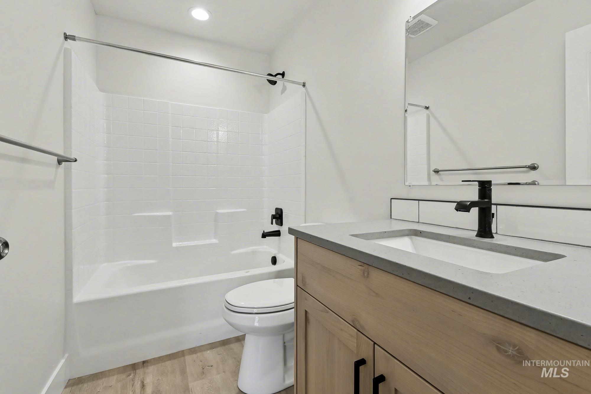 326 Packer Lane Homedale, ID 83628 - Photo 22 of 24 Full bath with vanity, shower / tub combination, and light wood-type flooring