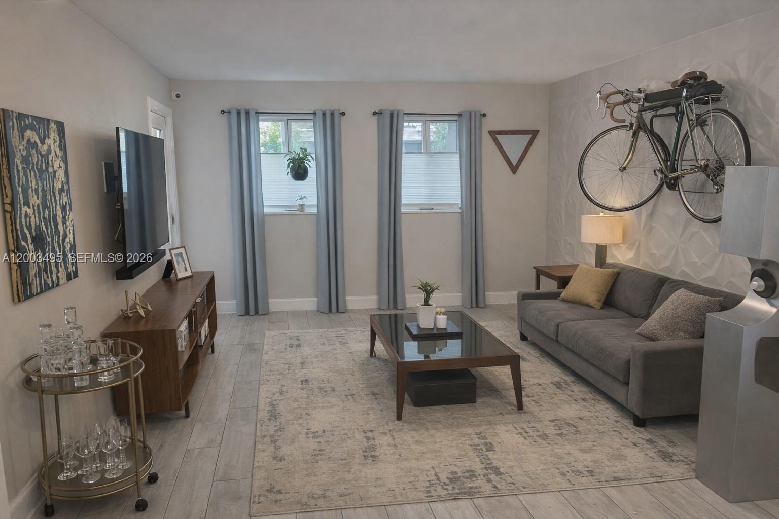 a living room with furniture a flat screen tv and a window
