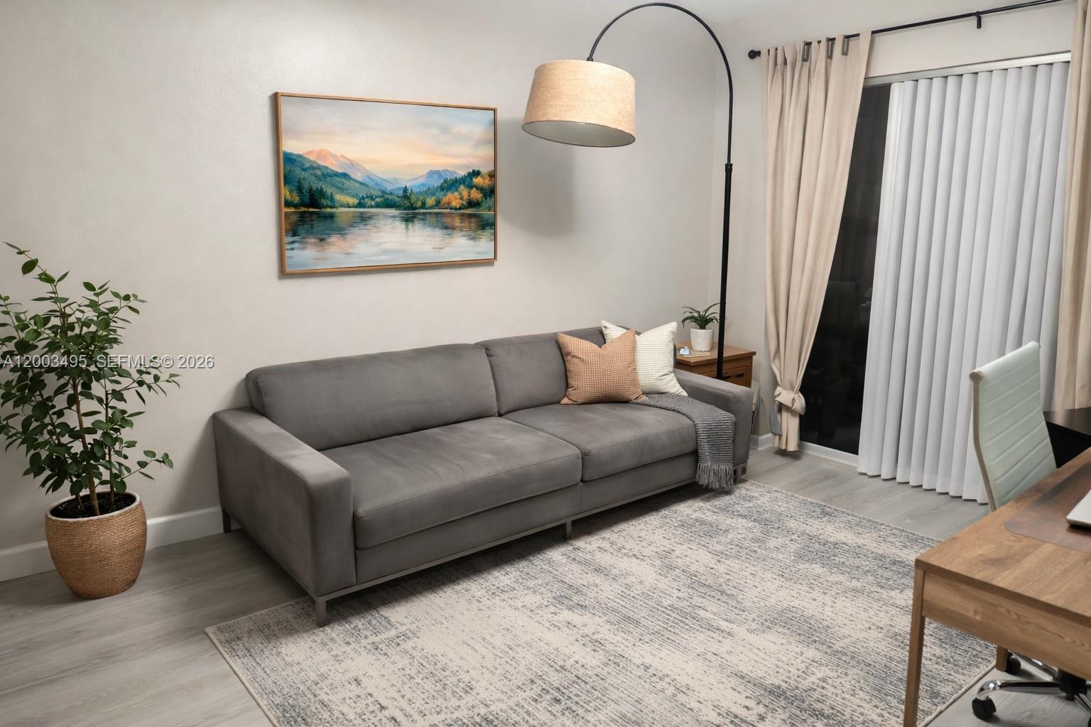 201 Northwest 7th Street, Unit 103 Miami, FL 33136 - Photo 5 of 9 a living room with furniture and a potted plant