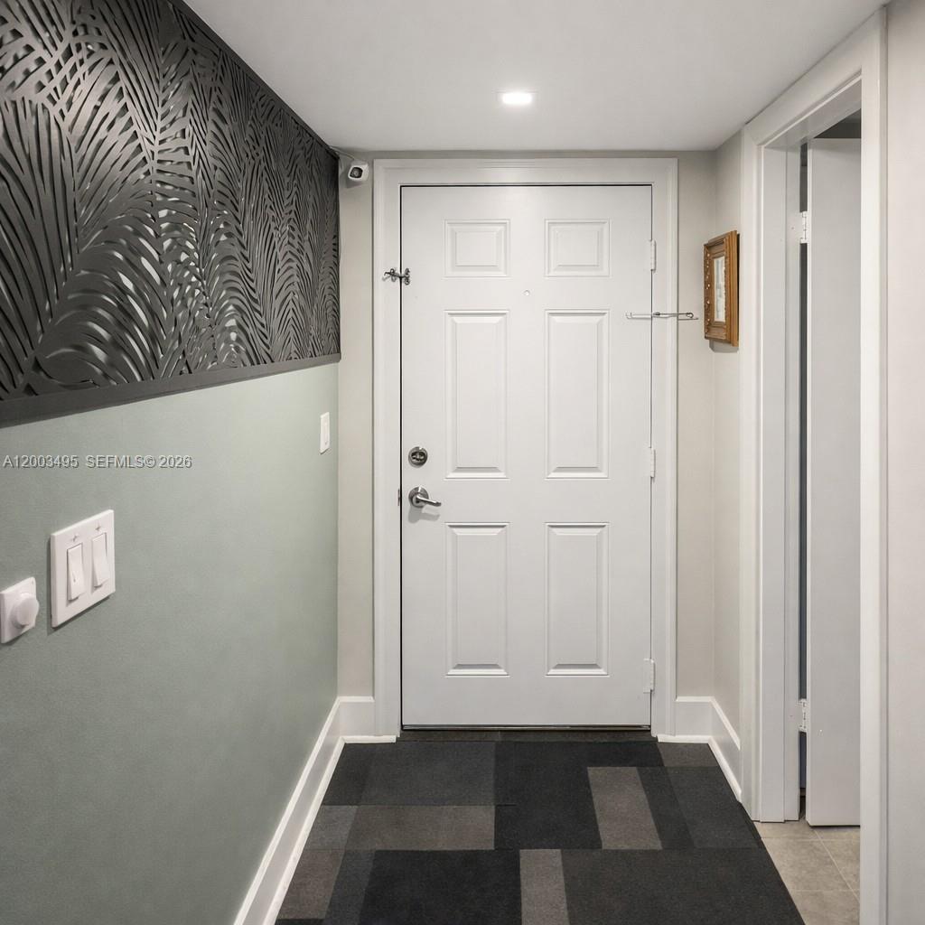 201 Northwest 7th Street, Unit 103 Miami, FL 33136 - Photo 6 of 9 a view of a hallway with wooden floor