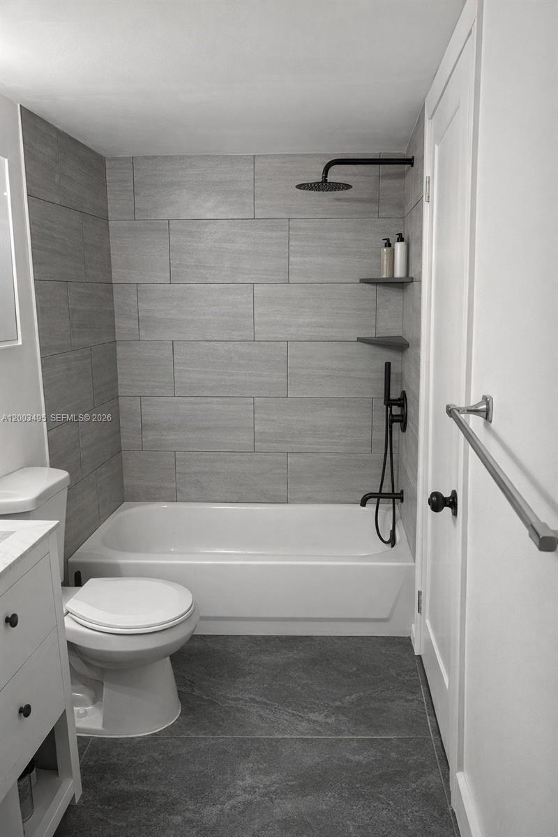 201 Northwest 7th Street, Unit 103 Miami, FL 33136 - Photo 7 of 9 a bathroom with a bathtub and a toilet