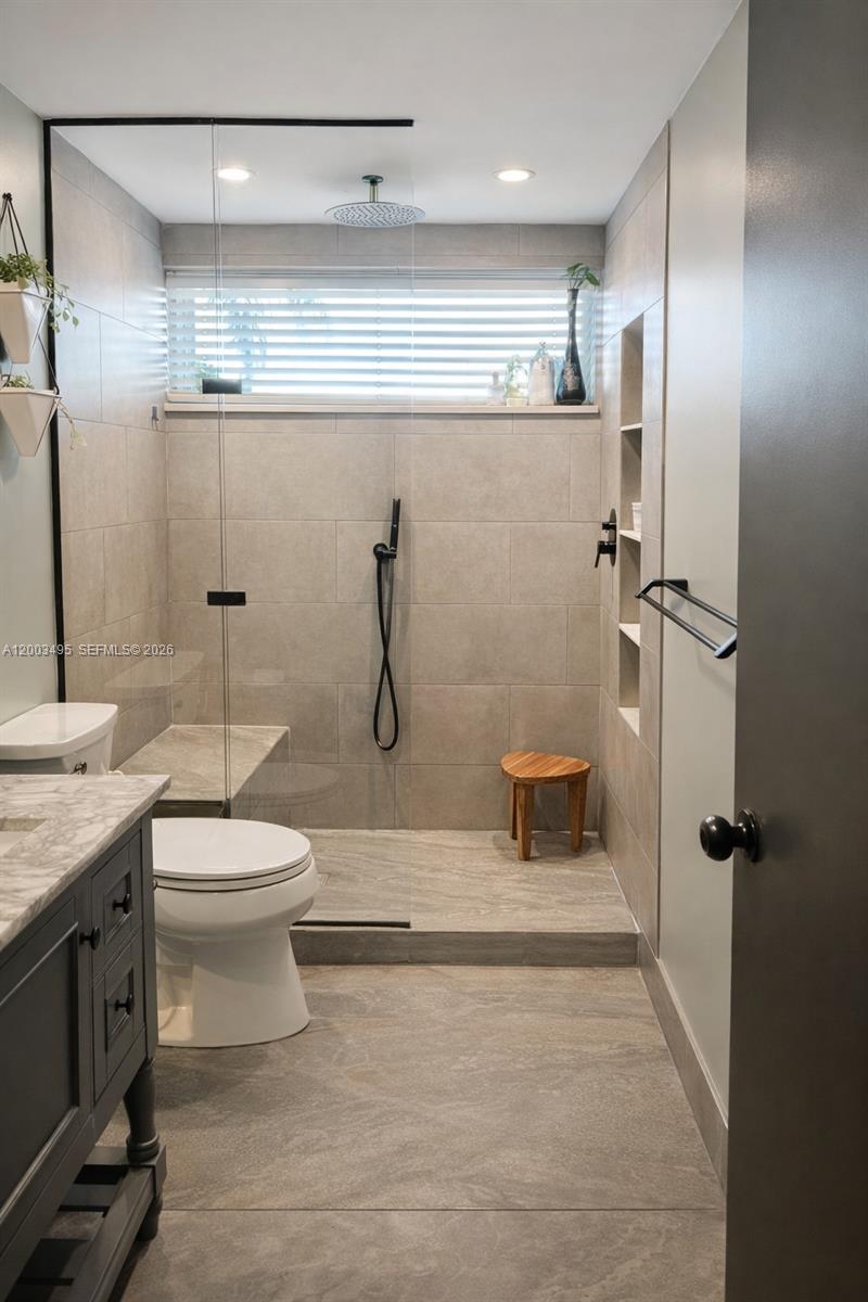 201 Northwest 7th Street, Unit 103 Miami, FL 33136 - Photo 8 of 9 a bathroom with a toilet sink and shower