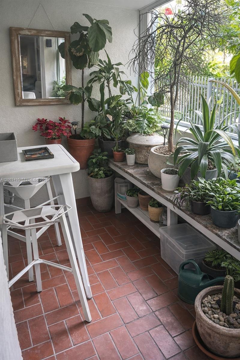 201 Northwest 7th Street, Unit 103 Miami, FL 33136 - Photo 9 of 9 a table with chairs and a potted plant