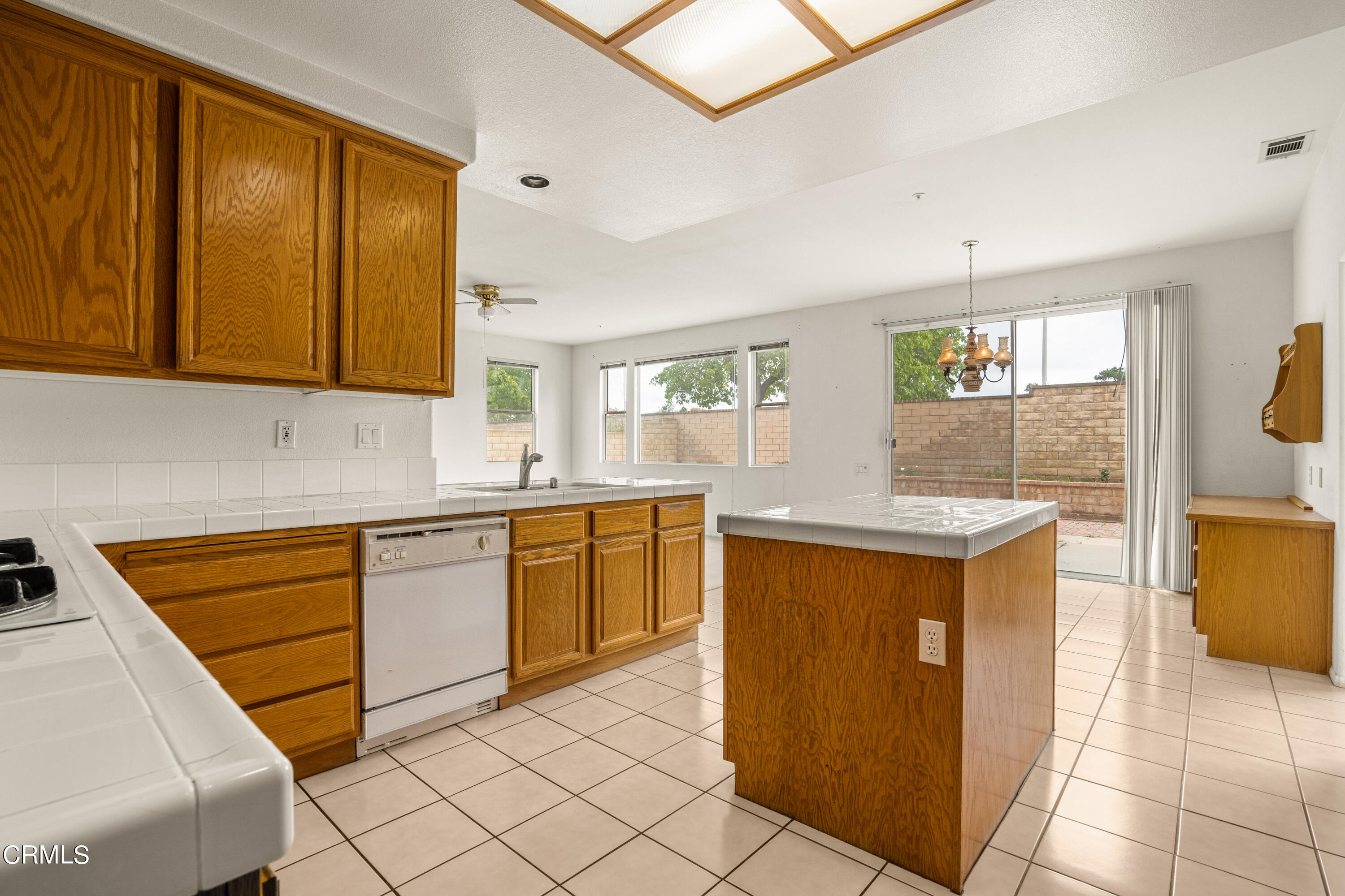 2410 Ivory Way Oxnard, CA 93036 - Photo 15 of 64 a kitchen with stainless steel appliances granite countertop a sink and a refrigerator