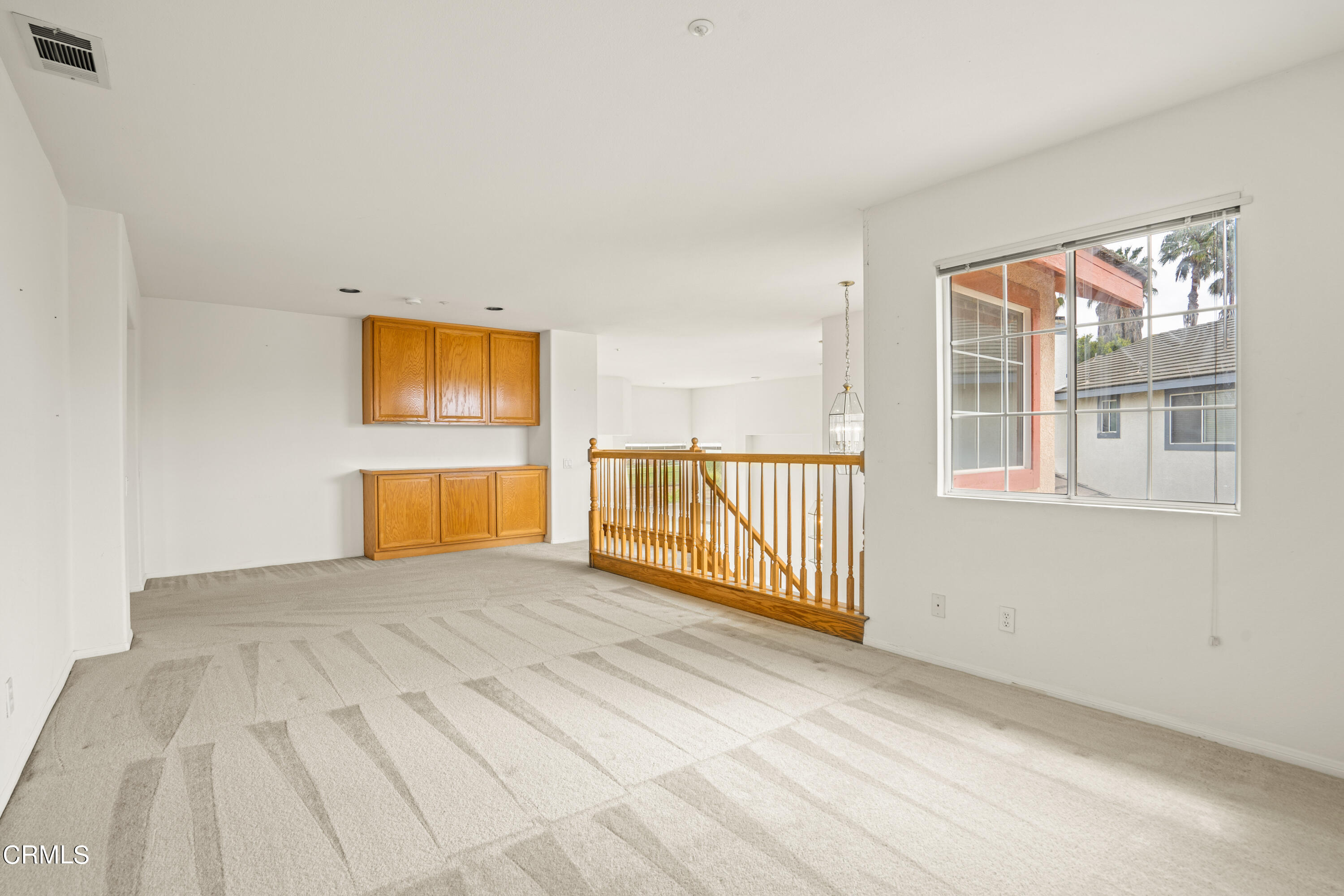 2410 Ivory Way Oxnard, CA 93036 - Photo 29 of 64 a view of a hallway with wooden floor and a bathroom
