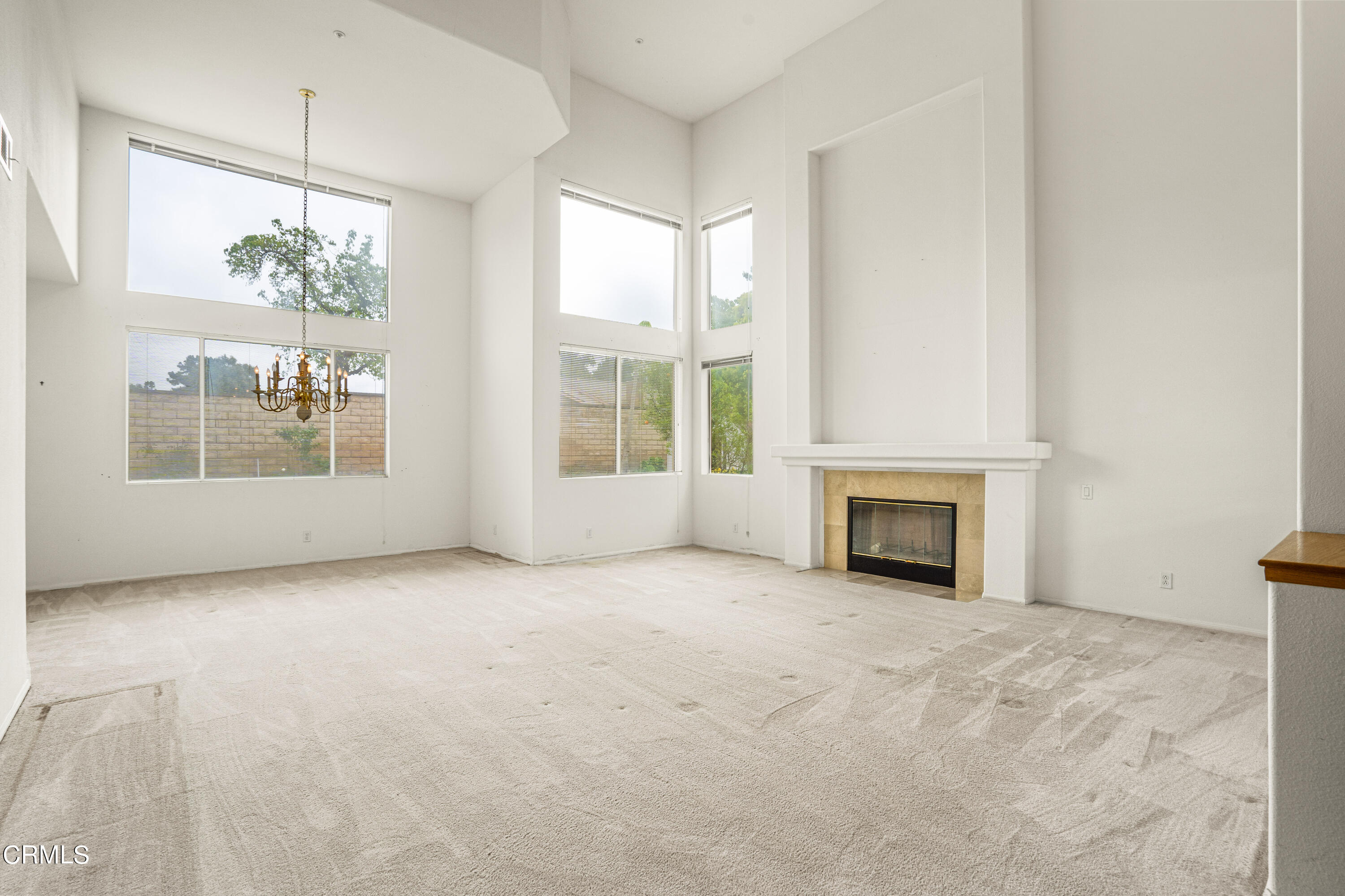 2410 Ivory Way Oxnard, CA 93036 - Photo 3 of 64 a view of an empty room with a fireplace and a window