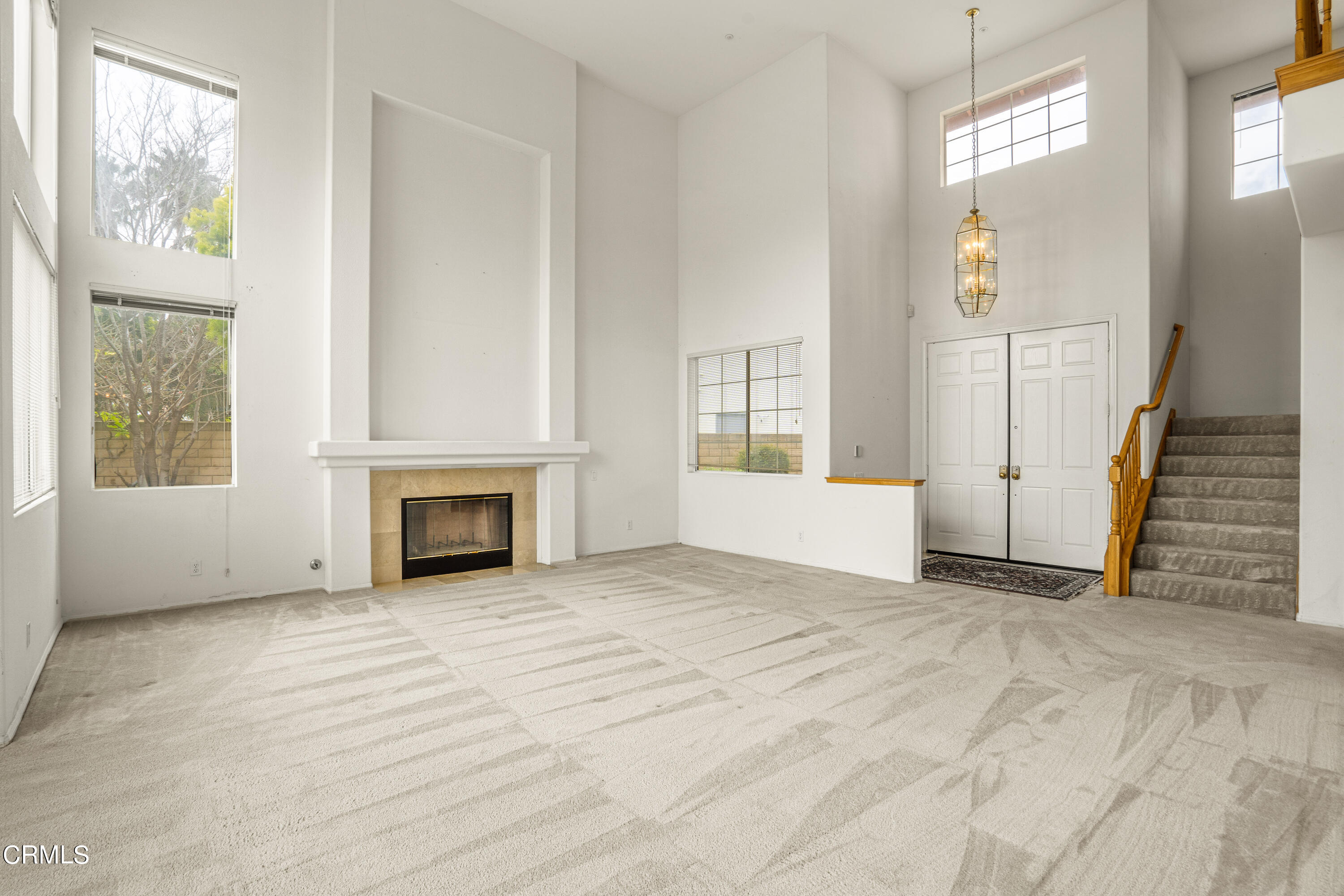 2410 Ivory Way Oxnard, CA 93036 - Photo 5 of 64 a view of an empty room with a fireplace and a window