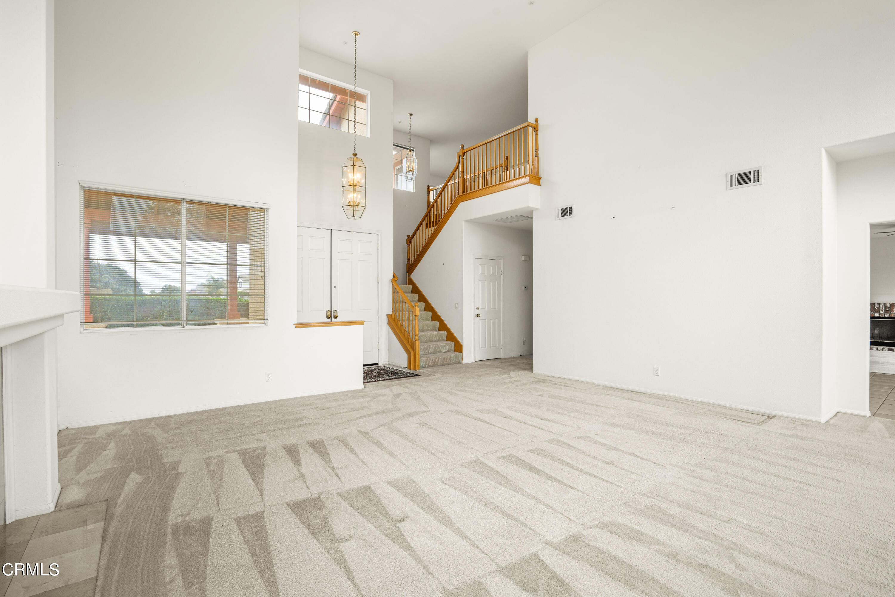 2410 Ivory Way Oxnard, CA 93036 - Photo 8 of 64 a view of an empty room with wooden floor and a window