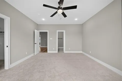 a view of a hallway with stairs and wooden floor