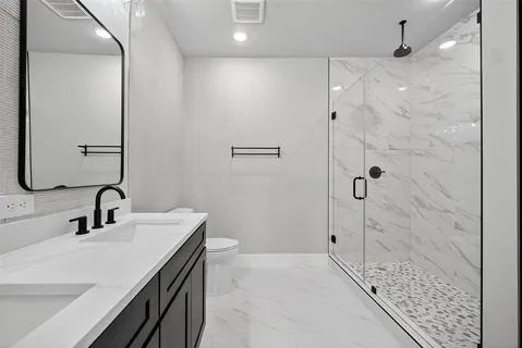 an empty room with closet and windows