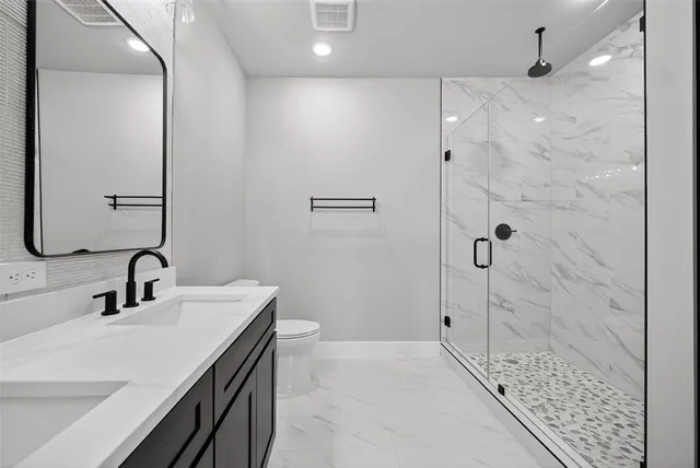 an empty room with closet and windows