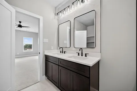 a bathroom with a sink a toilet a shower and a mirror