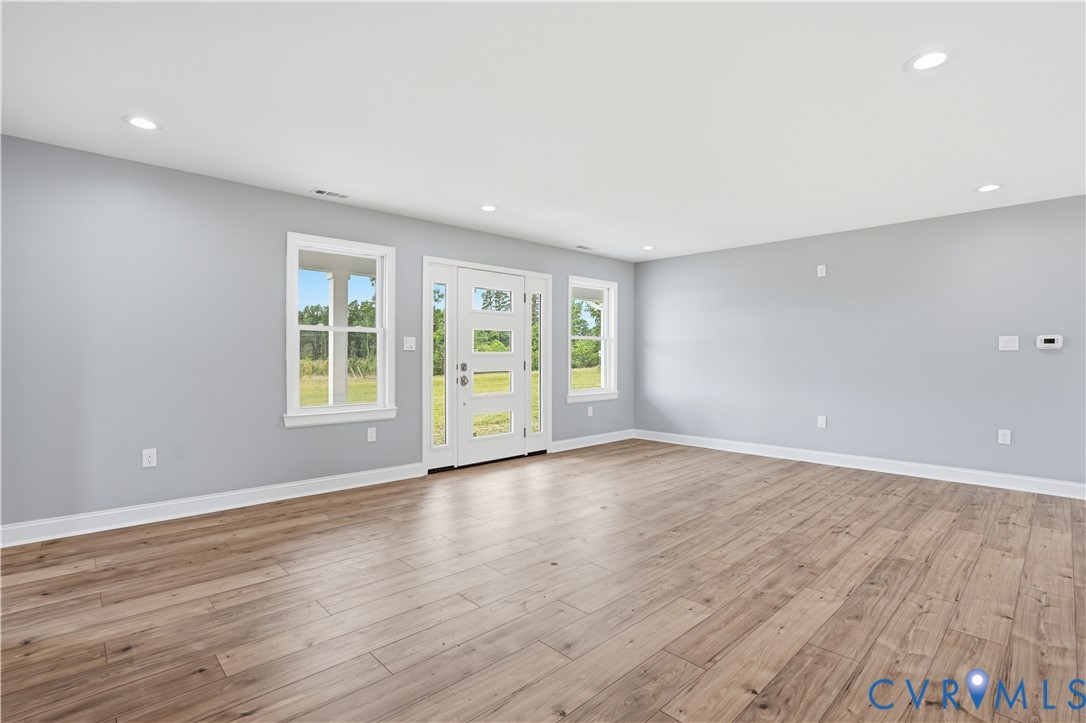 7839 King William Road Aylett, VA 23009 - Photo 7 of 38 a view of an empty room with wooden floor and windows