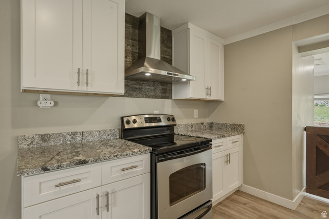 500 North 800 East Springville, UT 84663 - Photo 14 of 51 Kitchen with stainless steel range with electric cooktop, white cabinetry, light stone counters, and light wood-style flooring