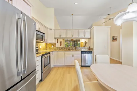 a kitchen with a refrigerator a sink and cabinets
