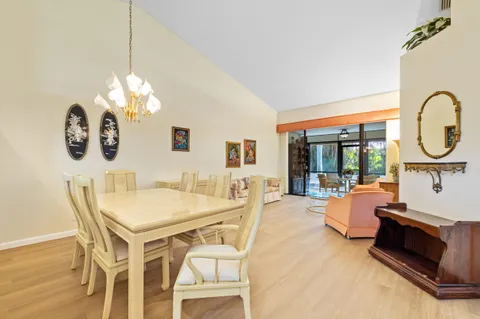 a view of a dining room with furniture wooden floor and chandelier