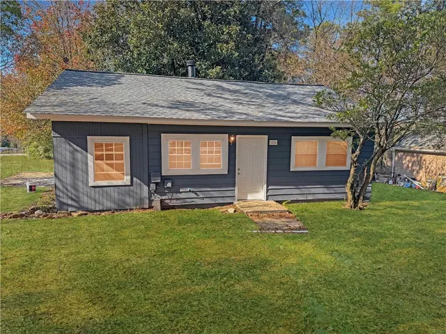 a backyard of a house with barbeque oven