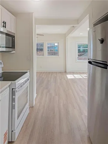 a kitchen with a refrigerator a stove top oven a sink and dishwasher
