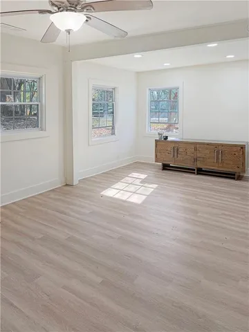 a view of wooden floor and windows in a room