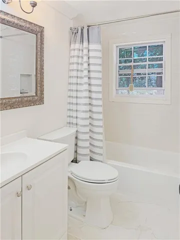 a white toilet sitting next to a bathroom sink