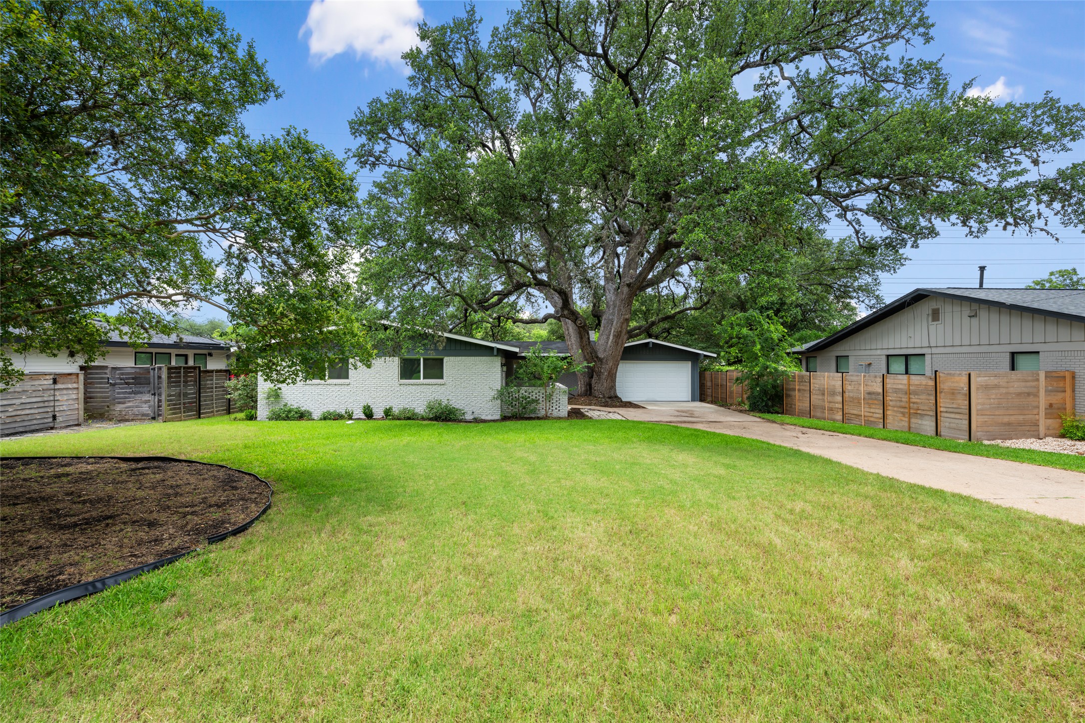 Mature trees frame this charming residence, offering abundant shade and a spacious yard.