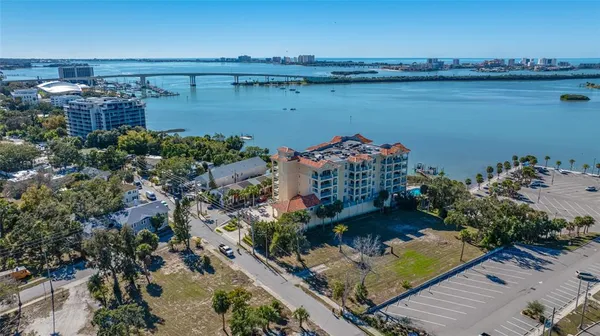 an aerial view of a house with a yard and lake view