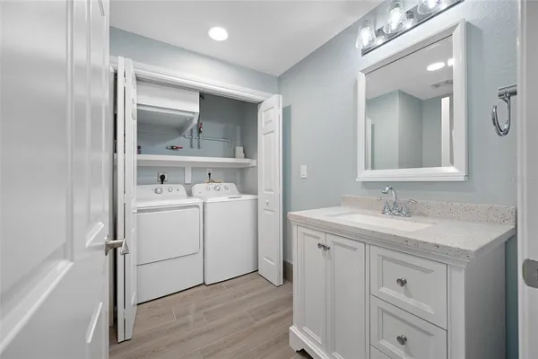 a bathroom with a tub sink and shower
