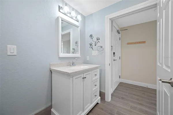 a bathroom with a granite countertop sink mirror and vanity