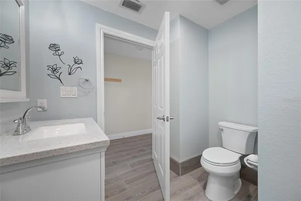 a bathroom with a toilet a sink and shower
