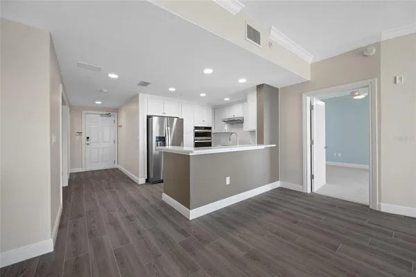 a living room with a couch and a dresser next to a window