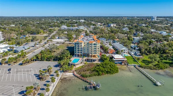 an aerial view of a house with outdoor space lake view and sitting area