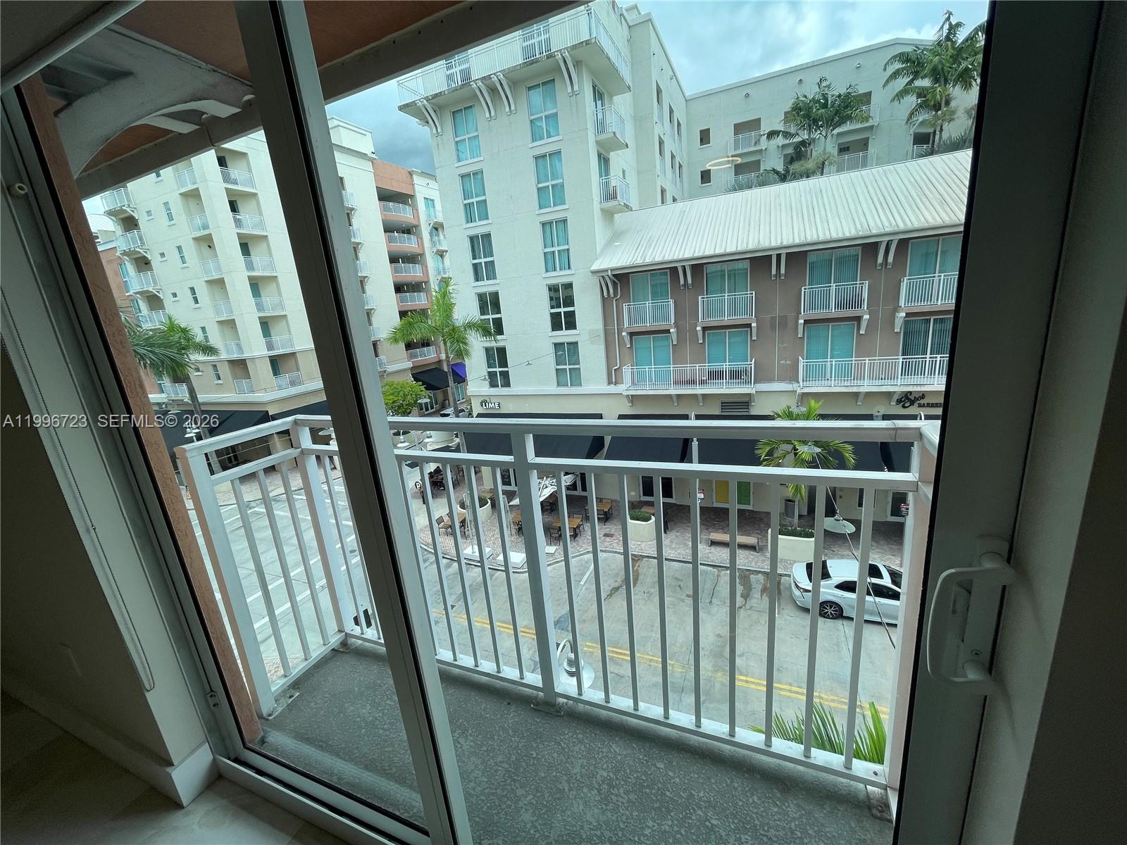 7290 Southwest 90th Street, Unit 307 Miami, FL 33156 - Photo 11 of 14 a view of a balcony with wooden floor
