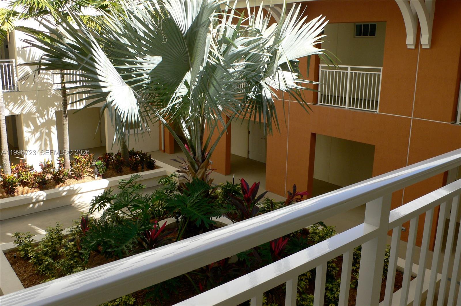 7290 Southwest 90th Street, Unit 307 Miami, FL 33156 - Photo 13 of 14 a view of a house with a flower garden
