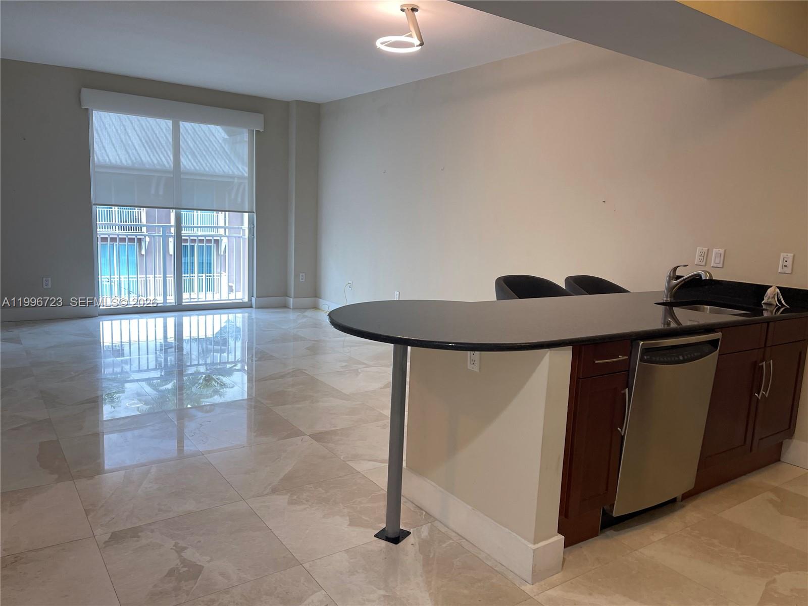 7290 Southwest 90th Street, Unit 307 Miami, FL 33156 - Photo 2 of 14 a kitchen with a sink a counter top space and cabinets